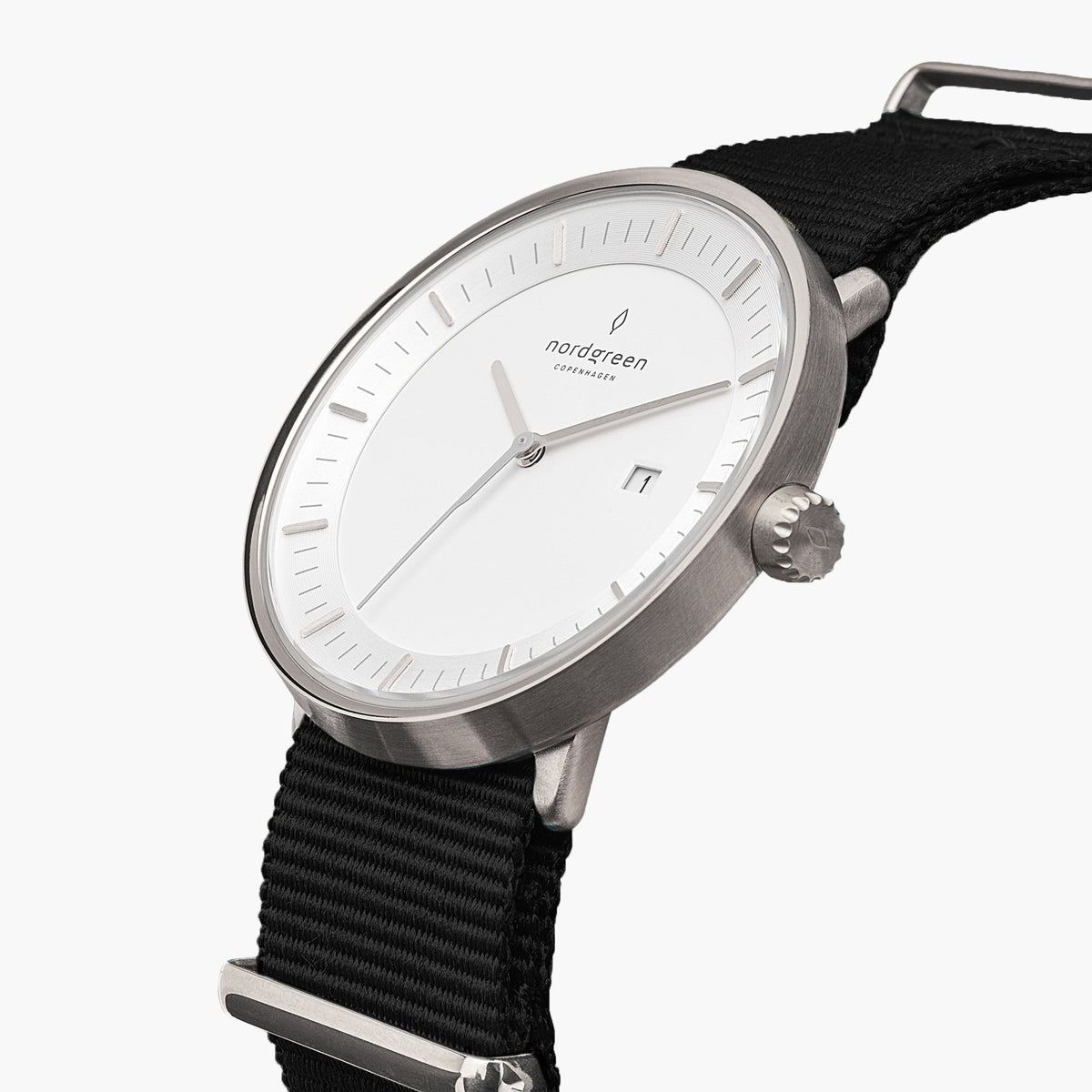 Three-quarter view of the silver-tone case and date window on a black fabric strap.