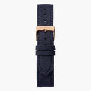 Navy woven-texture strap with tonal stitching and a rose gold-tone buckle.