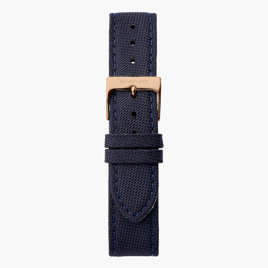 Navy woven-texture strap with tonal stitching and a rose gold-tone buckle.