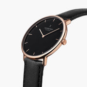 Angled view of the rose gold-tone case and black dial, crown on the right side.