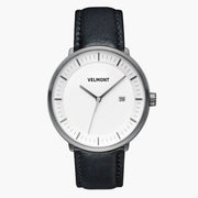 Straight-on look at the white dial and gunmetal case with its black strap.