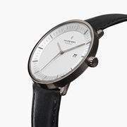 Three-quarter view of the watch showing the white dial and black strap.