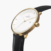 Three-quarter view of the gold-tone case, crown and date window.