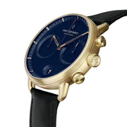 Angled view of the gold-tone case showing both pushers and the fluted crown.