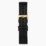 Close look at the black strap and its gold-tone pin buckle.