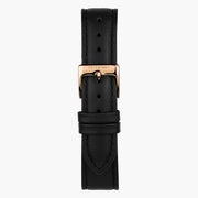 Detached black strap fastened with a rose gold-tone pin buckle.
