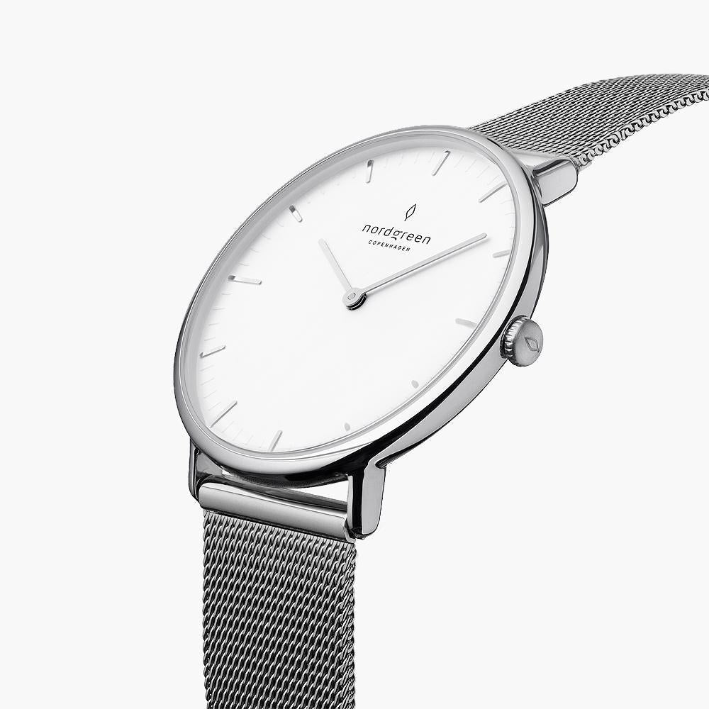 Angled view of the silver-tone case showing the crown and woven mesh.