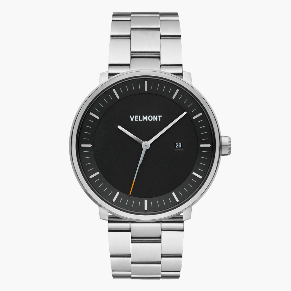 Black-dial watch with an orange-tipped seconds hand on a silver-tone bracelet.