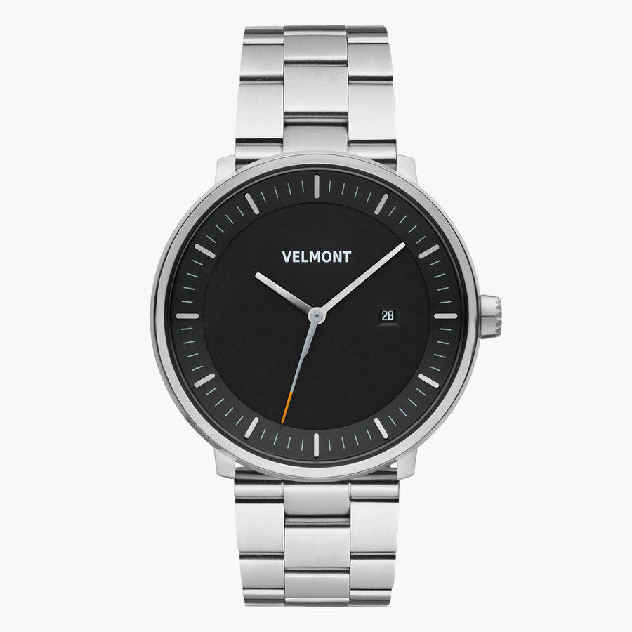 Black-dial watch with an orange-tipped seconds hand on a silver-tone bracelet.