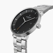 Angled view of the black dial, date window and silver-tone crown.