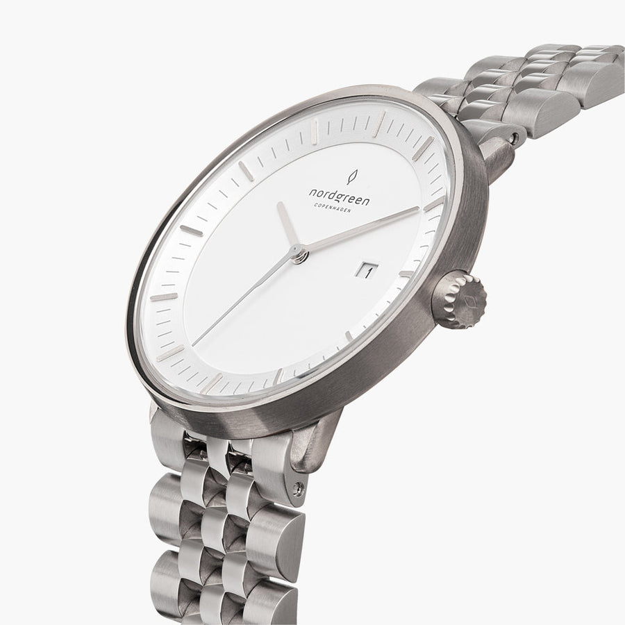 The silver-tone watch tilted to reveal its white dial and side crown.