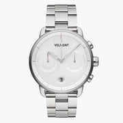 Chronograph-style watch with a white dial on a silver-tone three-row bracelet.