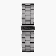 Three-row gunmetal bracelet with a fold-over clasp, laid flat.