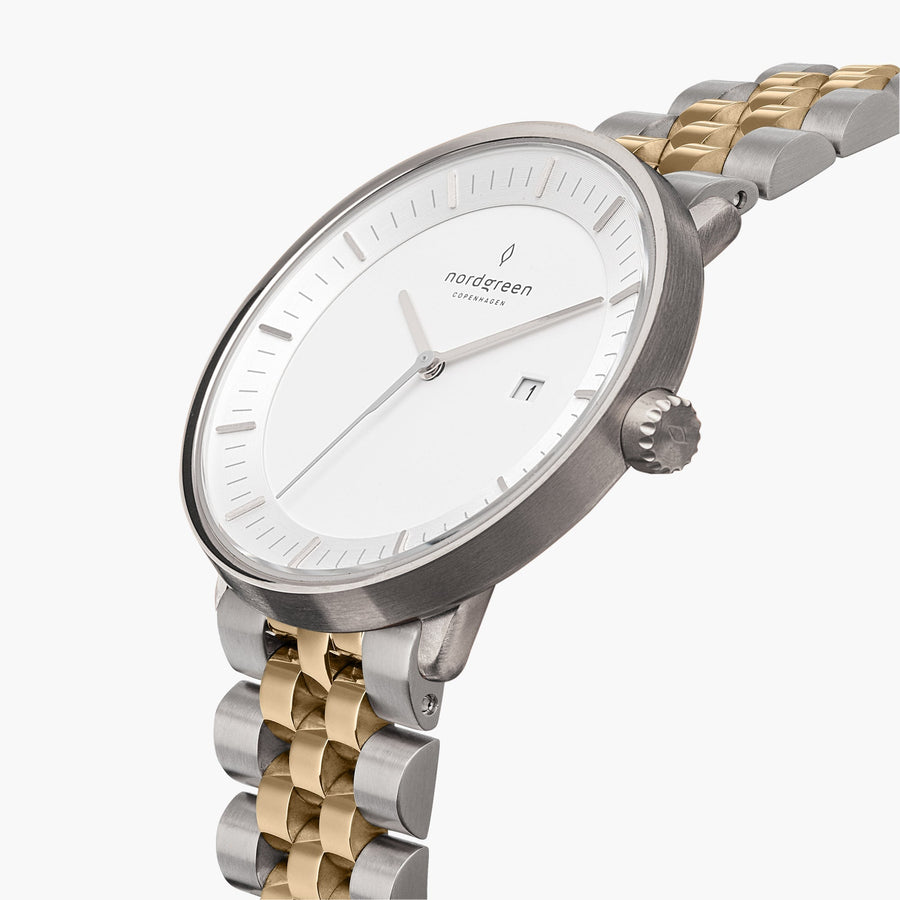 Angled view of the silver-tone case and white dial, crown on the right side.