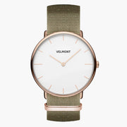 Slim rose gold-tone watch with a white two-hand dial on an olive green fabric strap.