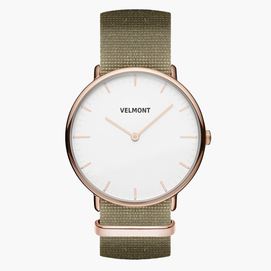 Slim rose gold-tone watch with a white two-hand dial on an olive green fabric strap.