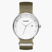 White-dial watch in a silver-tone case on an olive green woven band, front view.