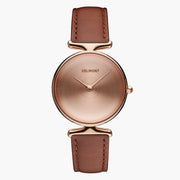 Watch with a rose gold-tone dial and case on a caramel brown strap, front view.