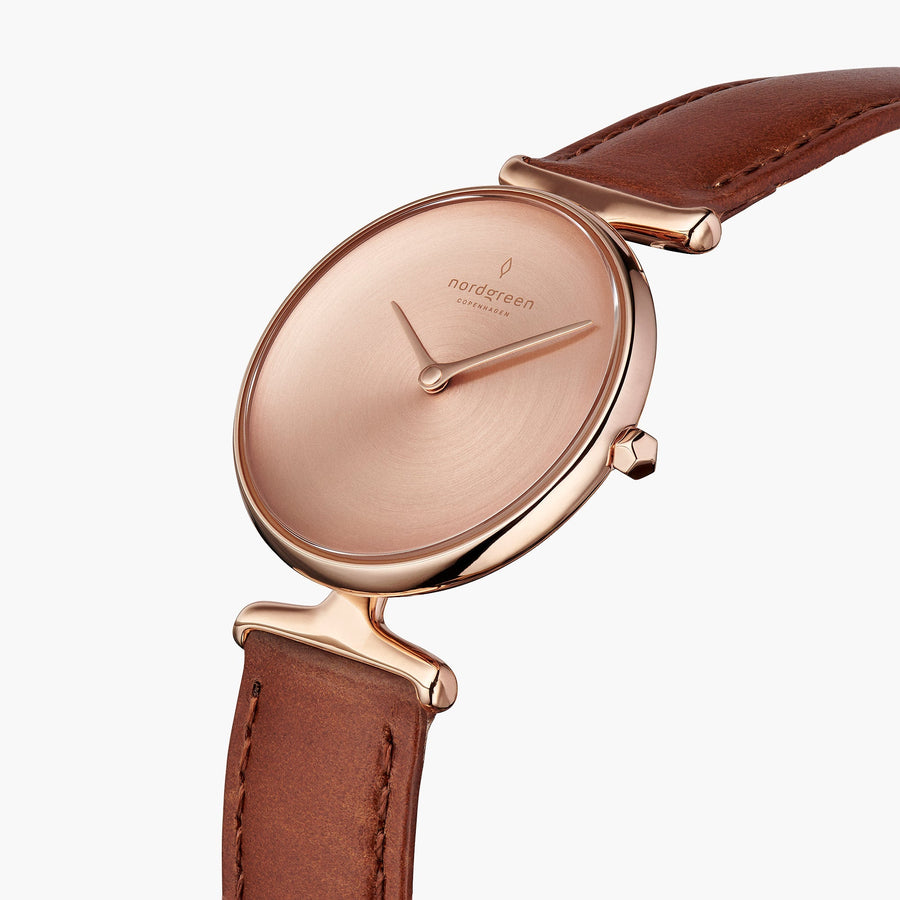 Angled view of the sculpted lugs and faceted crown in rose gold tone.