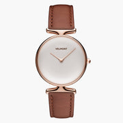 Watch with a plain white dial and rose gold-tone case on a brown strap, front view.