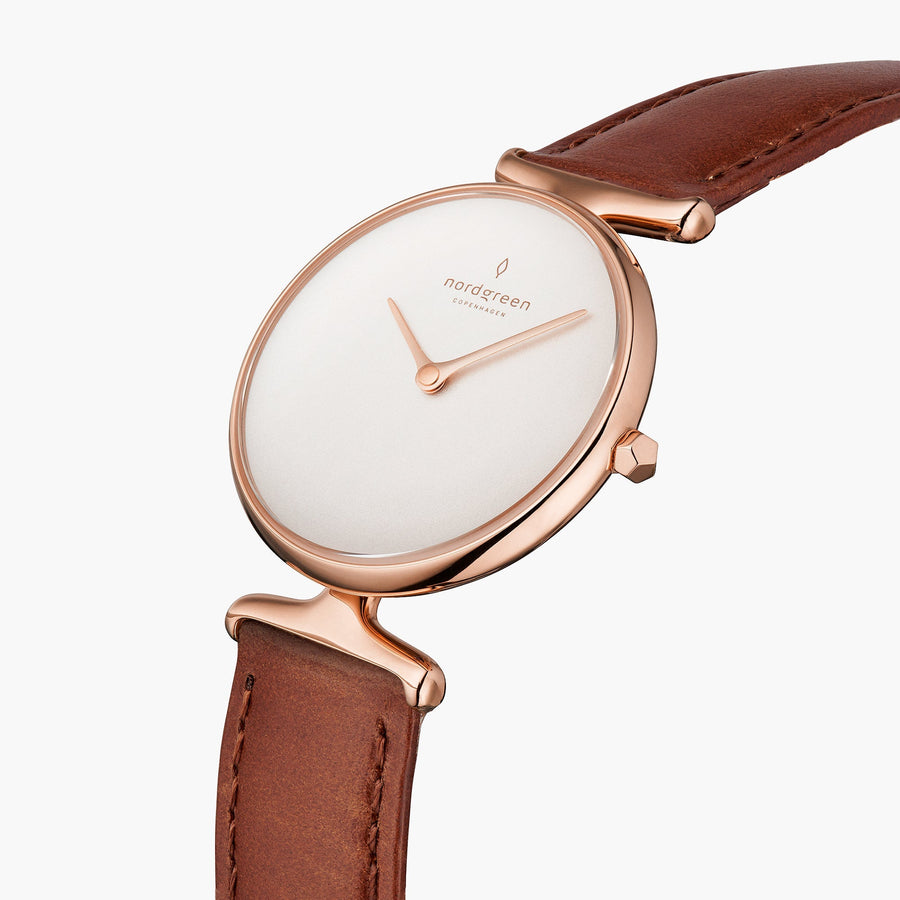 Angled view of the sculpted rose gold-tone lugs and faceted crown.