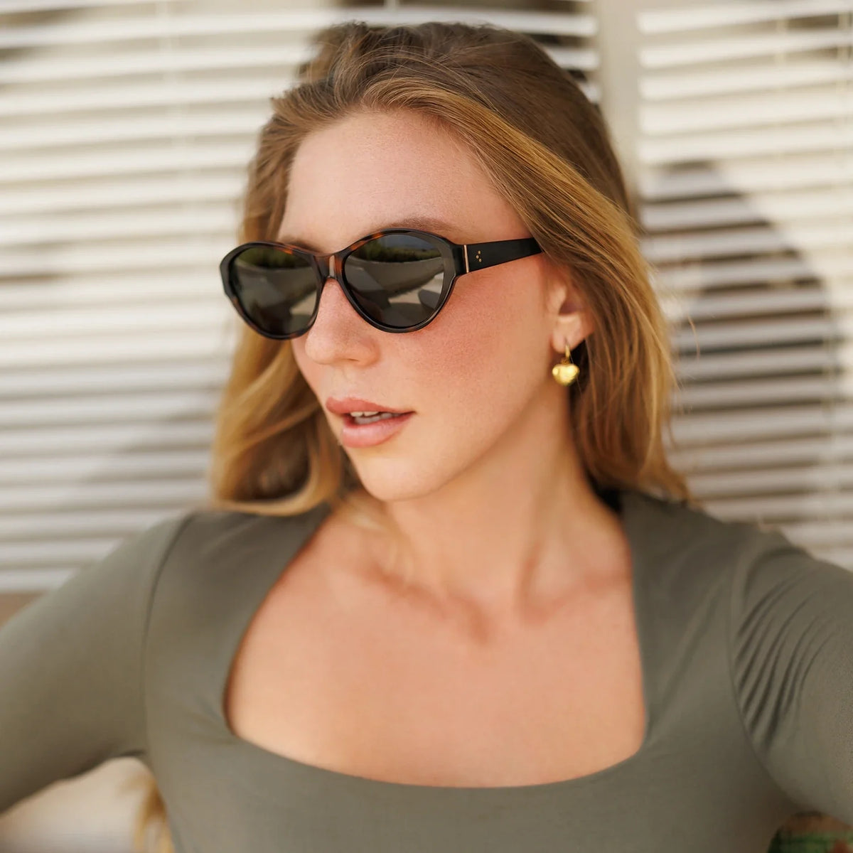Woman in cat eye sunglasses looking aside