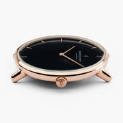 Profile of the watch head in rose gold-tone, crown facing the camera.