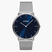 Navy sunburst dial in a silver-tone case on a silver-tone mesh strap.