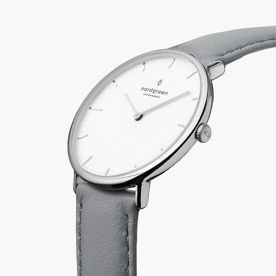 Three-quarter view of the slim silver-tone case on a soft gray strap.