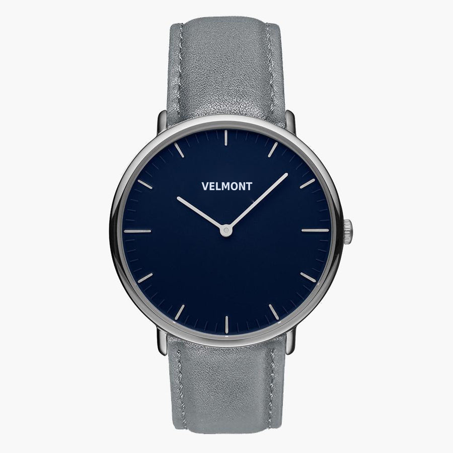 Watch with a navy blue dial and silver-tone case on a gray strap.