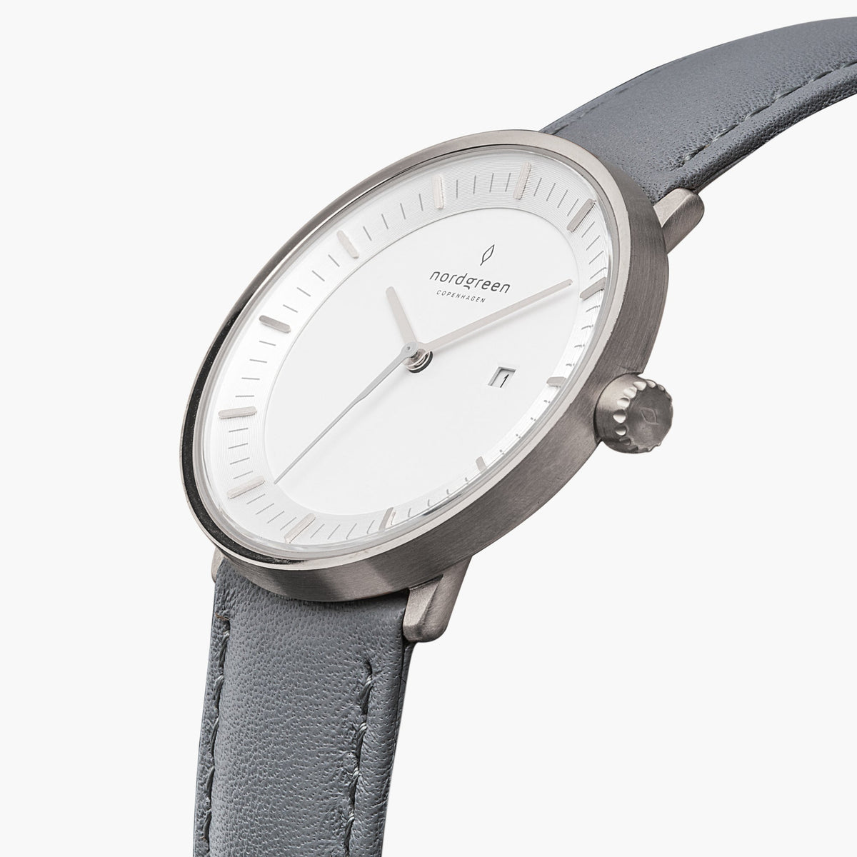 Three-quarter view of the silver-tone case and date window on a gray strap.