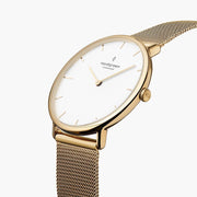 Angled view of the thin gold-tone case and white dial with gold-tone hands.