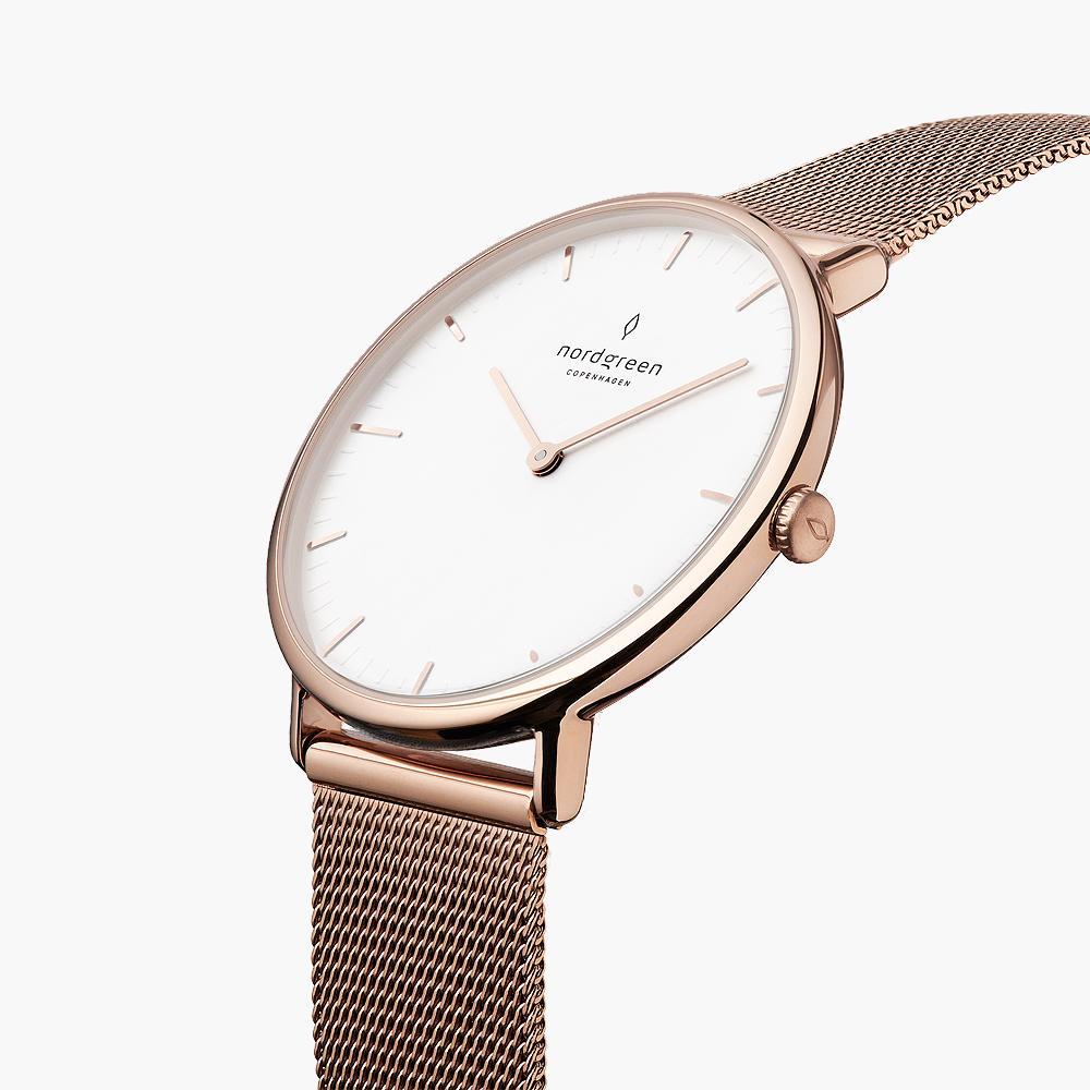 Rose gold-tone case and crown at an angle, white dial in view.