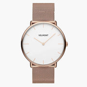 White-dial watch in rose gold tone with a fine mesh strap, front facing.