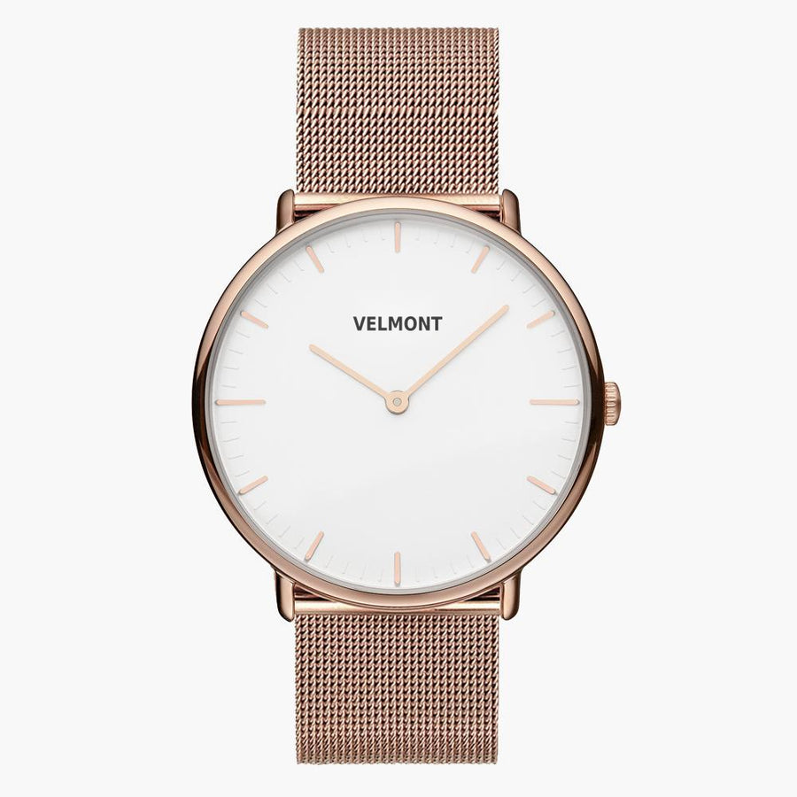White-dial watch in rose gold tone with a fine mesh strap, front facing.
