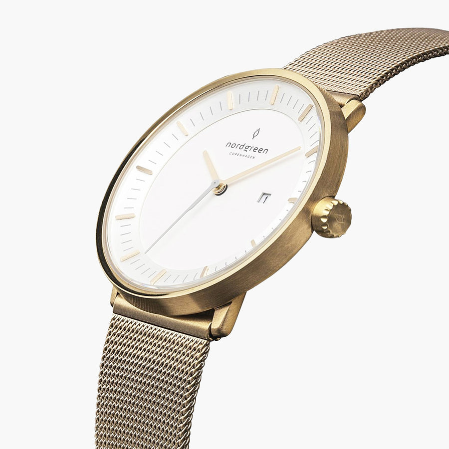 Gold-tone 40 mm watch with white dial at an angle, showing the date window
