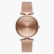 All rose gold-tone watch with a plain dial, sculpted lugs and mesh strap.