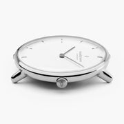 Low side angle of the silver-tone case with the white dial in view.