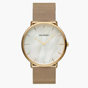 Gold-tone watch with a pearlescent white dial on a gold-tone mesh strap.