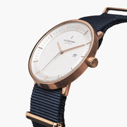 Angled view of the white dial with its date window and rose gold-tone crown.