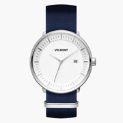 Watch with a white dial and silver-tone case on a navy woven strap.