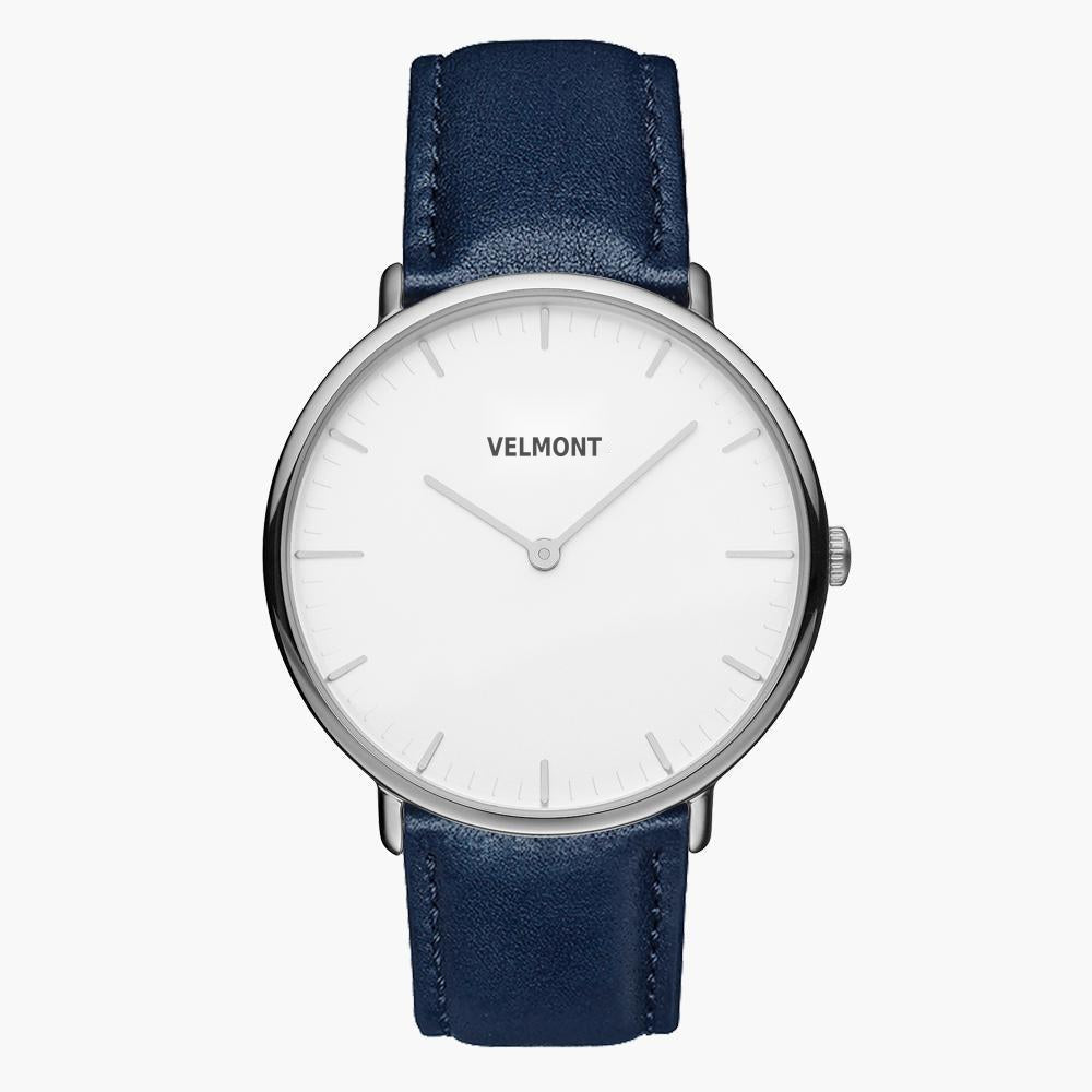 Minimalist watch with a white dial and silver-tone case on a navy strap.