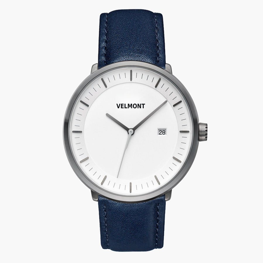 Watch with a white dial and gunmetal case on a navy strap, shown from the front.
