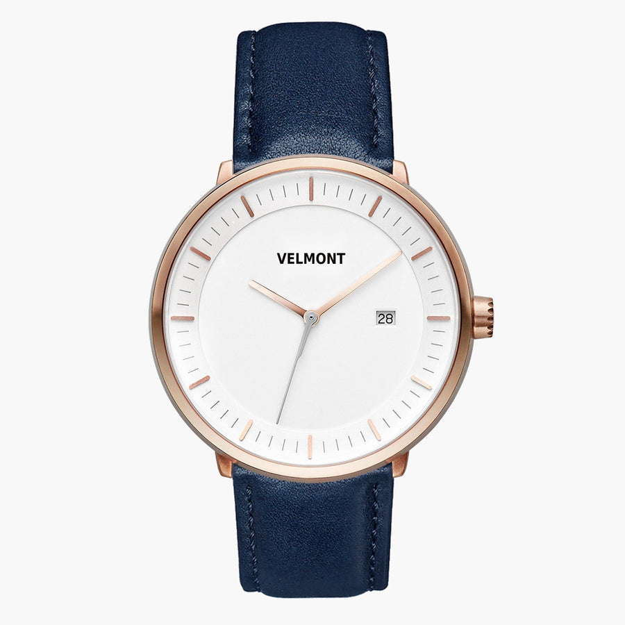 Watch with a white dial and rose gold-tone case on a smooth navy strap.