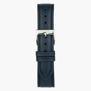 The navy strap laid flat, with a silver-tone buckle and keepers.