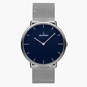 Watch with a deep blue matte dial and silver-tone case on a mesh strap.