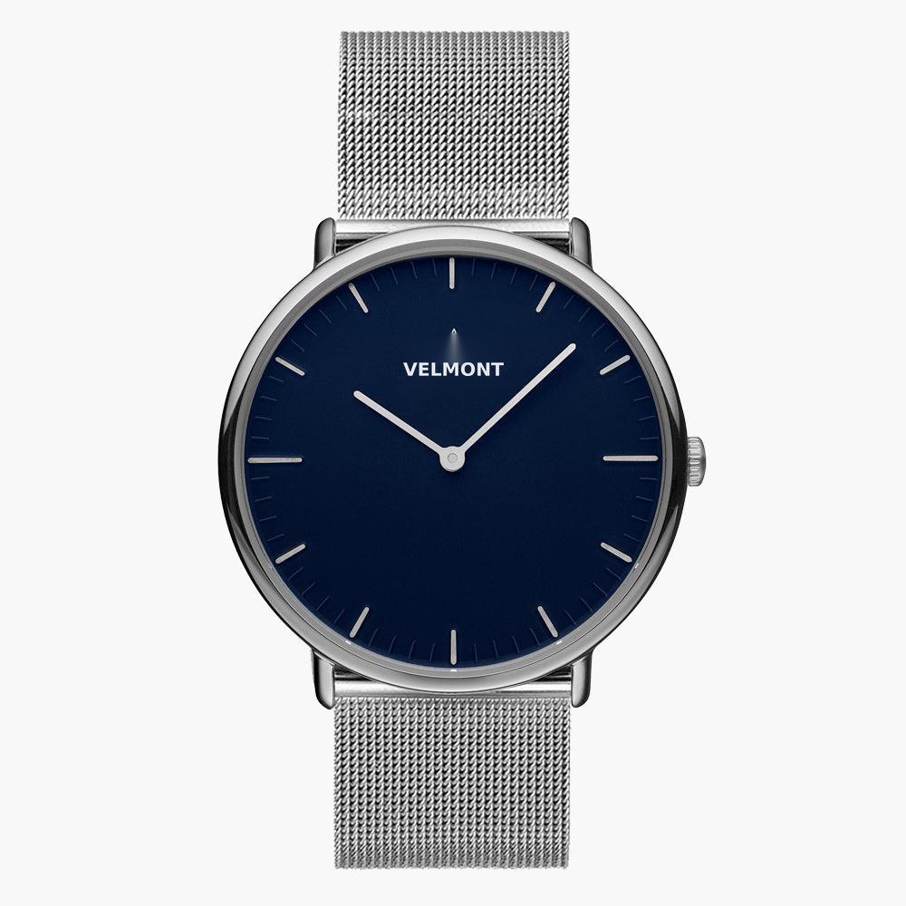 Watch with a deep blue matte dial and silver-tone case on a mesh strap.