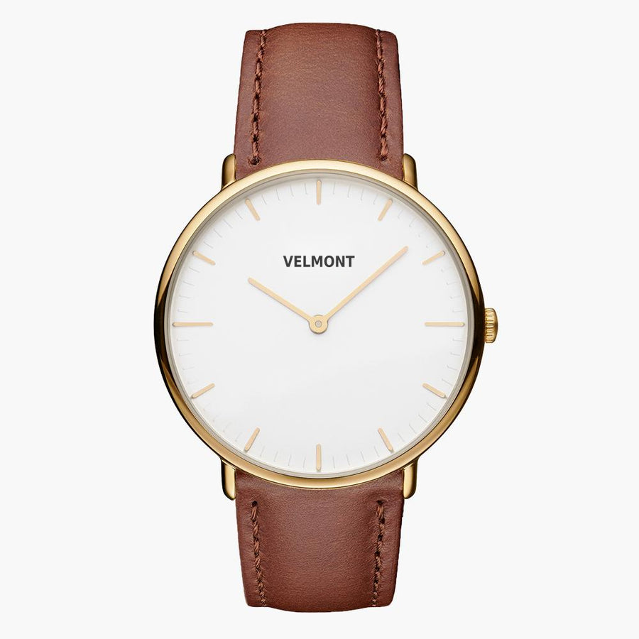 Watch with a gold-tone case and white dial on a smooth brown strap.