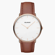 Rose gold-tone watch with a white dial on a brown strap, centered front view.