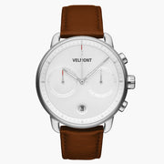 Chronograph-style watch with a white dial and silver-tone case on a brown strap.